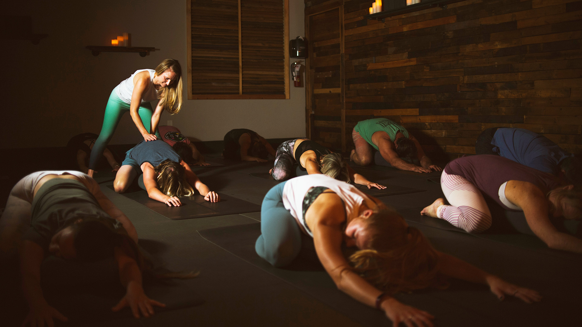 A group of people stretching during a class at Titanium Yoga